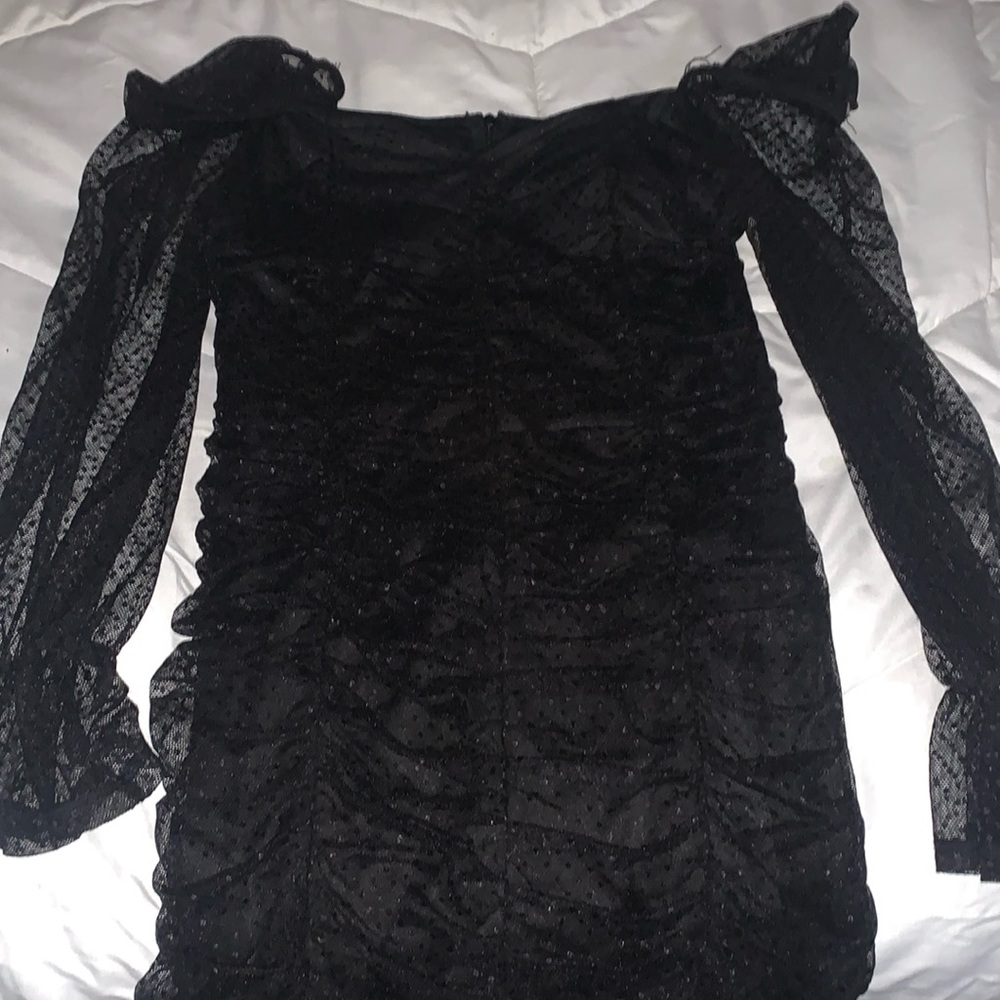 black dress with mesh sleeves a and ruffled body